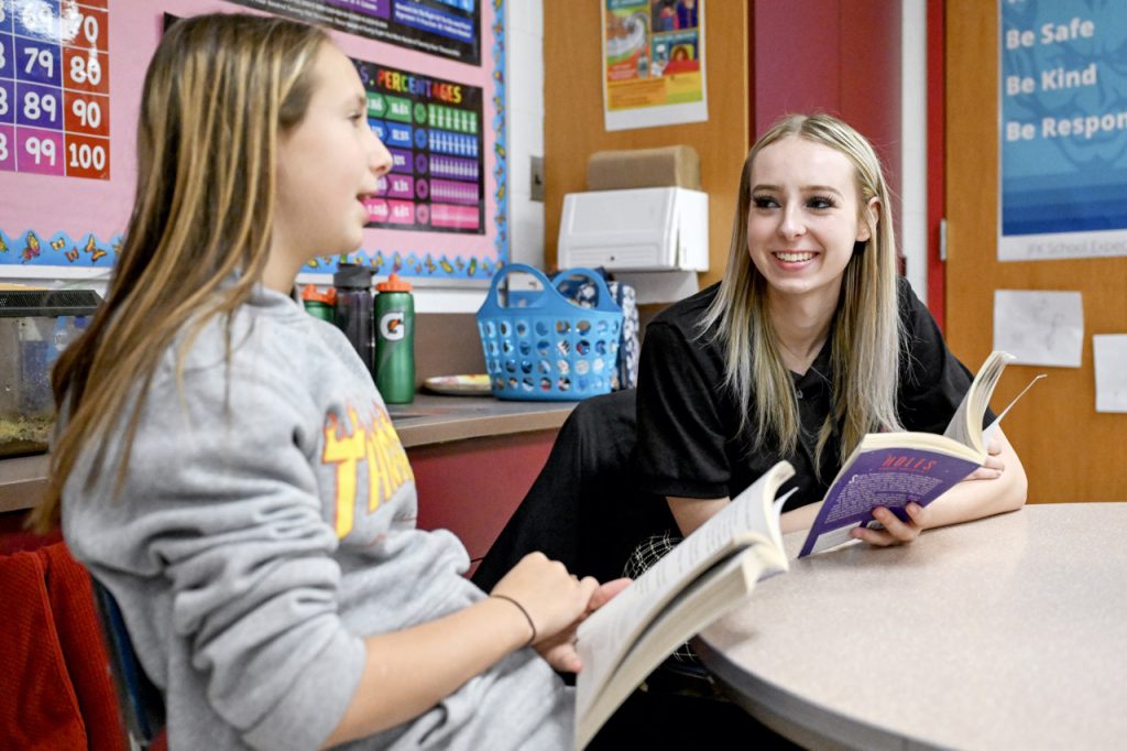 Student in the Education and Human Services Program work with a teen.