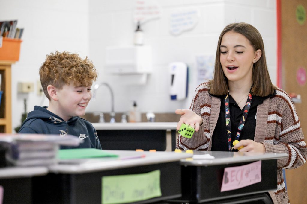 Student in the Education and Human Services Program works with a child.