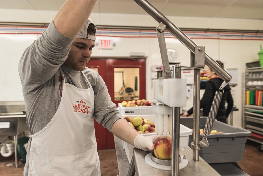 Harvest Kitchen team presses apples