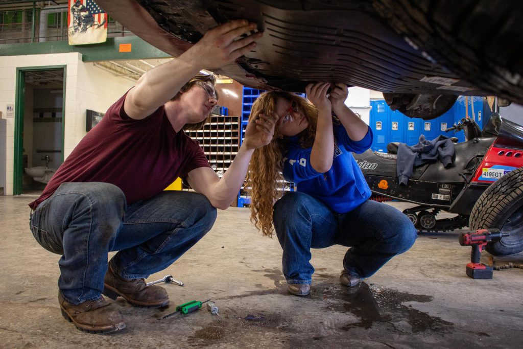 student performing automotive repair work