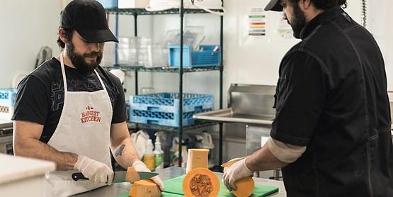 Harvest Kitchen team cuts cantelope