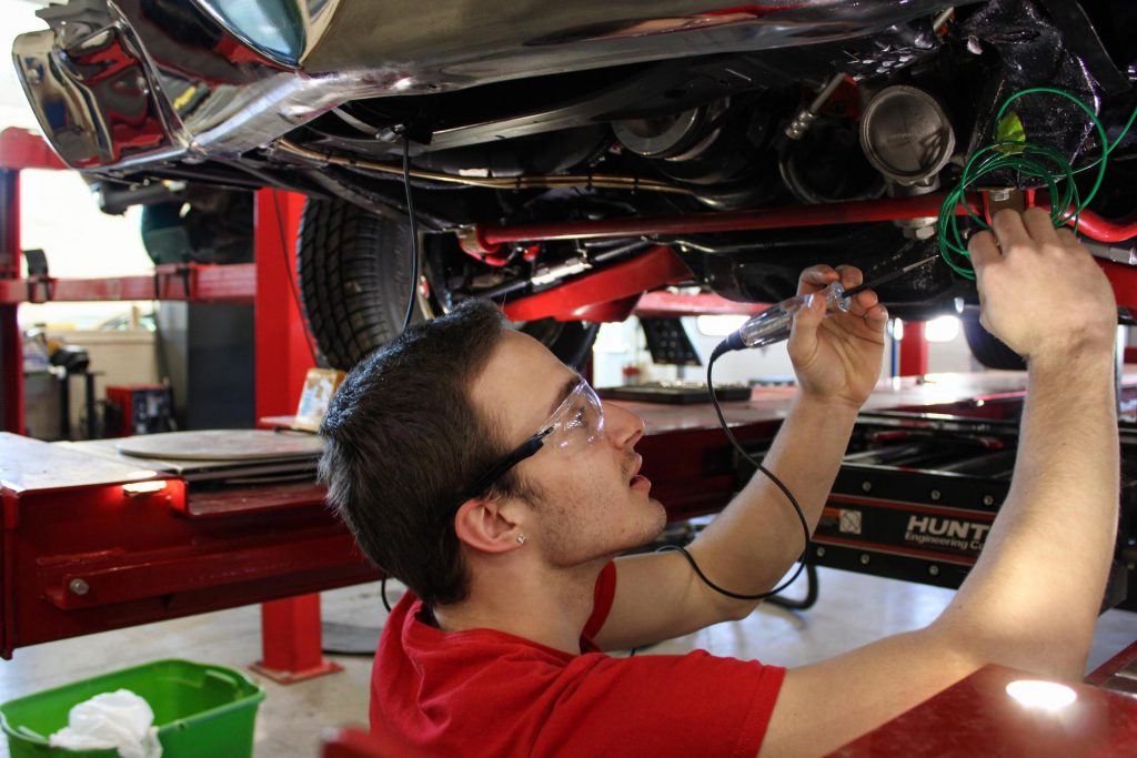 student performing automotive repair work